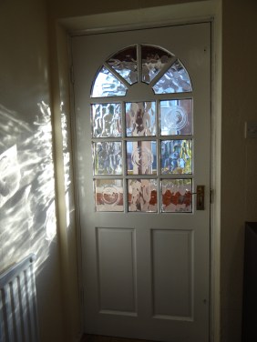 The front door's glass makes interesting patterns with the morning sunlight.