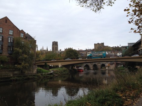 The Elvet Bridge is the one beyond the roadway bridge.  The Cathedral, the Castle, and a Double Decker Bus greet us on our morning commute.
